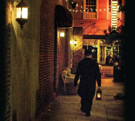 man walking down a dark alley