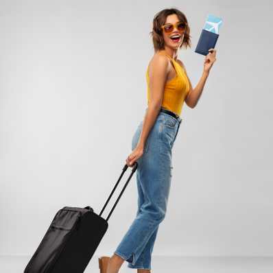 a girl with her ticket in her hand and suitcase in the other