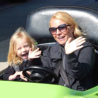 a mom and daughter in a go kart
