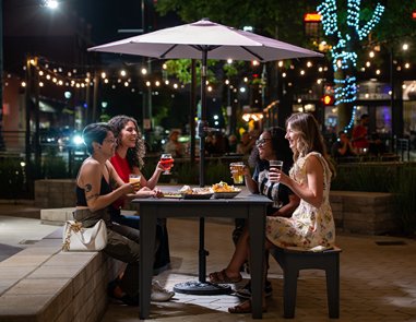 Group of four adults sitting together at dinner