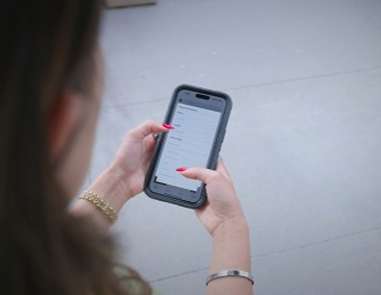 A phone that is open and someone is using it