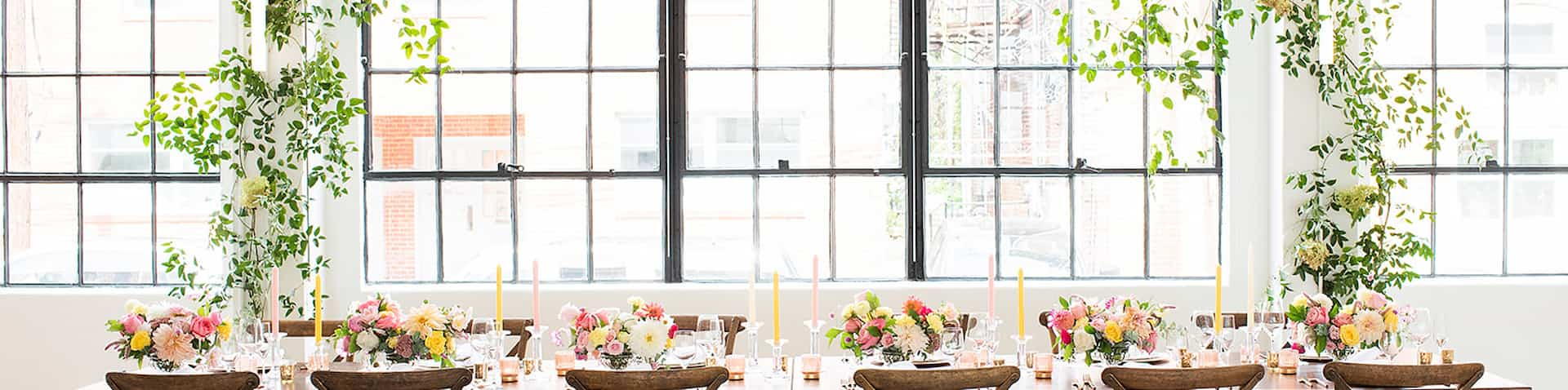 Table set up for event in Elm & Bain's meeting space with large window behind