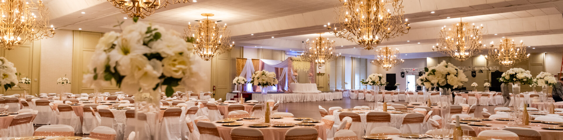 decorated room with tables and chandeliers