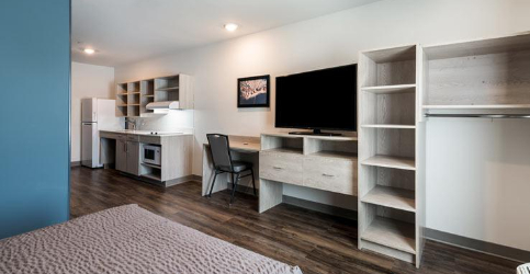 desk, shelves and tv in a room