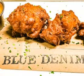 chicken paired with dipping sauce on a cutting board 