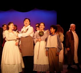actors smiling performing the Christmas Carol