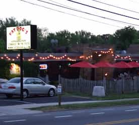 restaurant exterior at night with accent lighting on patio