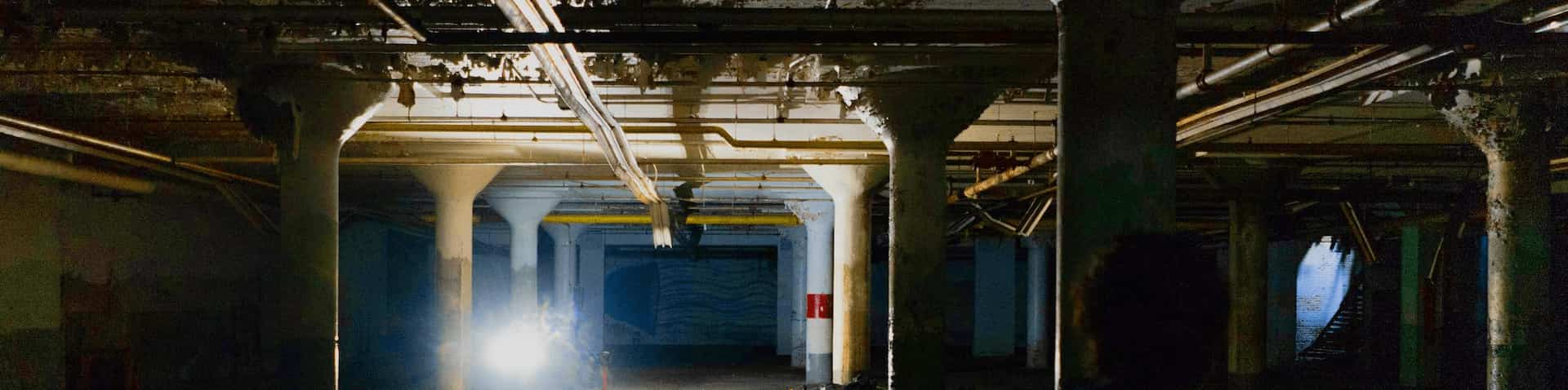 a guy walking in a eerie parking deck