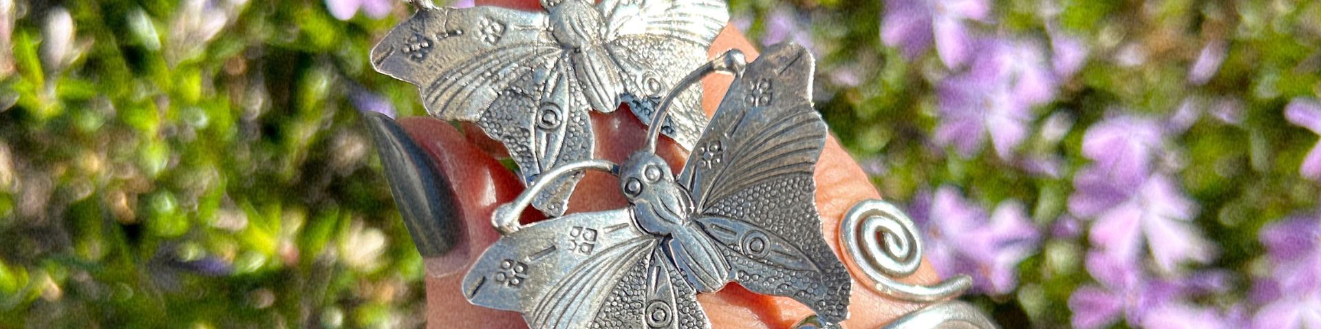 close-up of rings with floweres in background