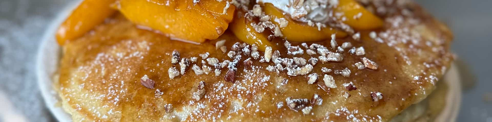 close-up of pancakes with syrup and toppings