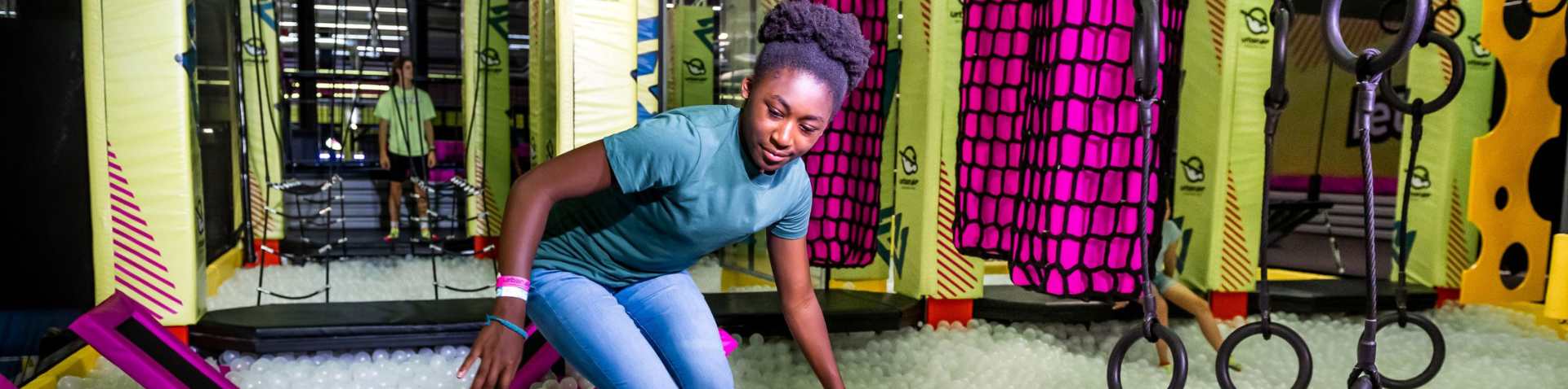 a girl on the air warrior course in the adventure park