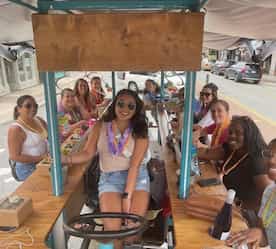 girls smiling on the brew peddlers trolley