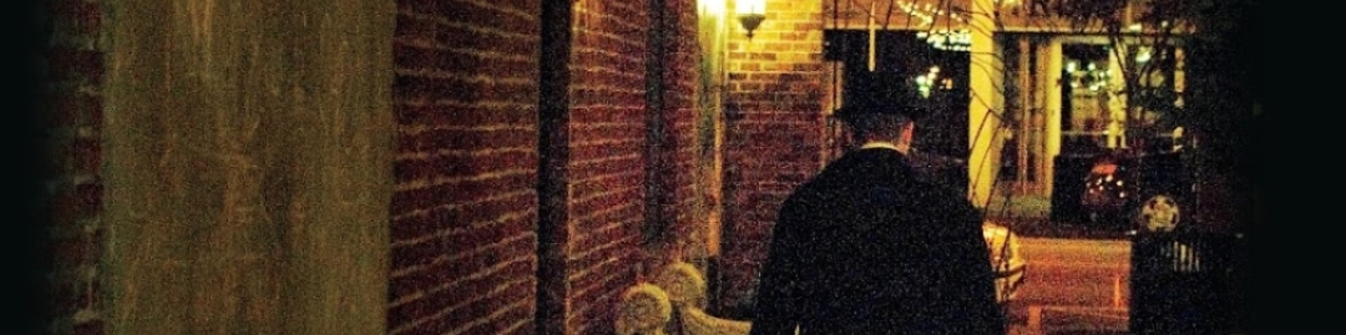 man walking down a dark alleyway