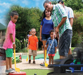 family playing mini golf