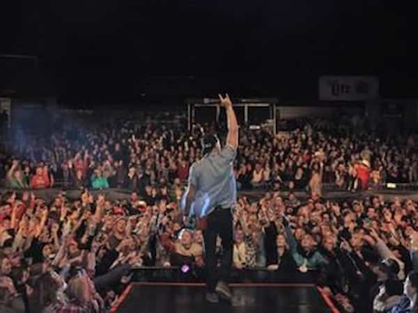 man performing in front of a large crowd