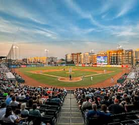 the baseball stadium with downtown skyline in the background