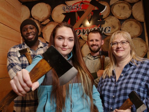 family enjoying axe throwing attraction