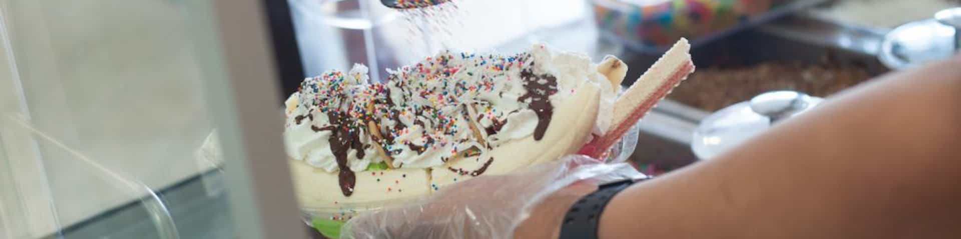 a Mexican dessert with bananas, whipping cream and sprinkles