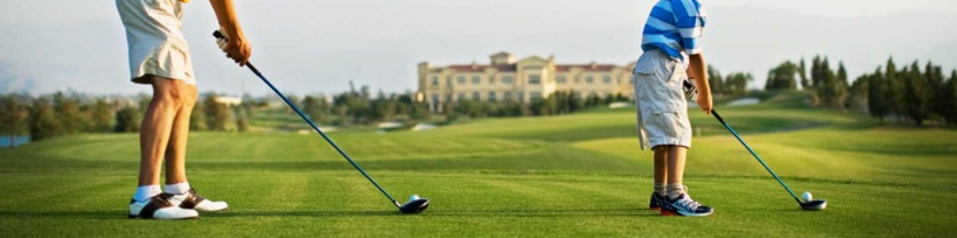 Man and child golfing