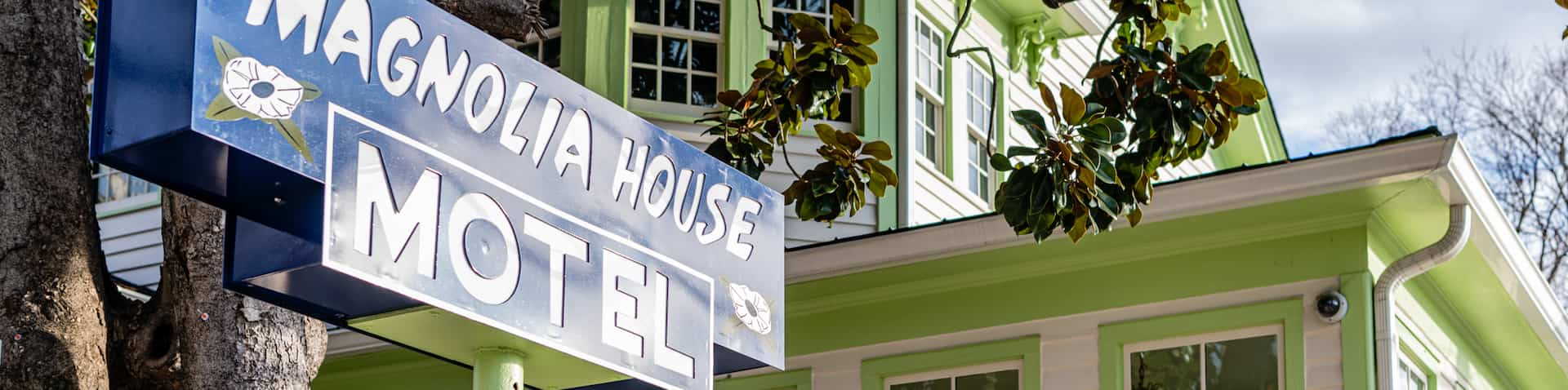 close-up of sign and the historic house in background