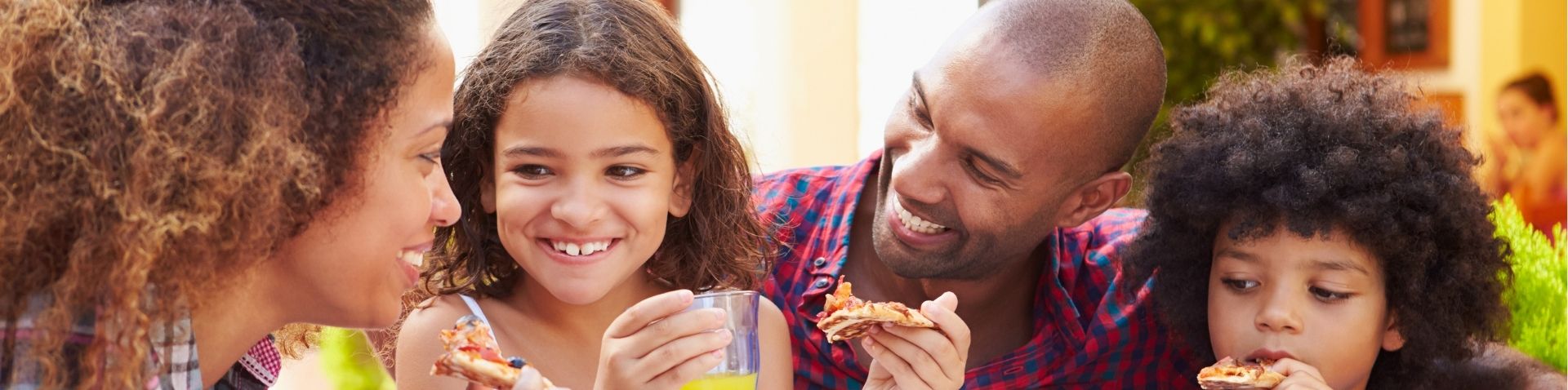a family enjoying pizza together