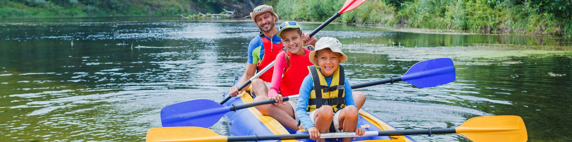 a dad kayaking with his kids