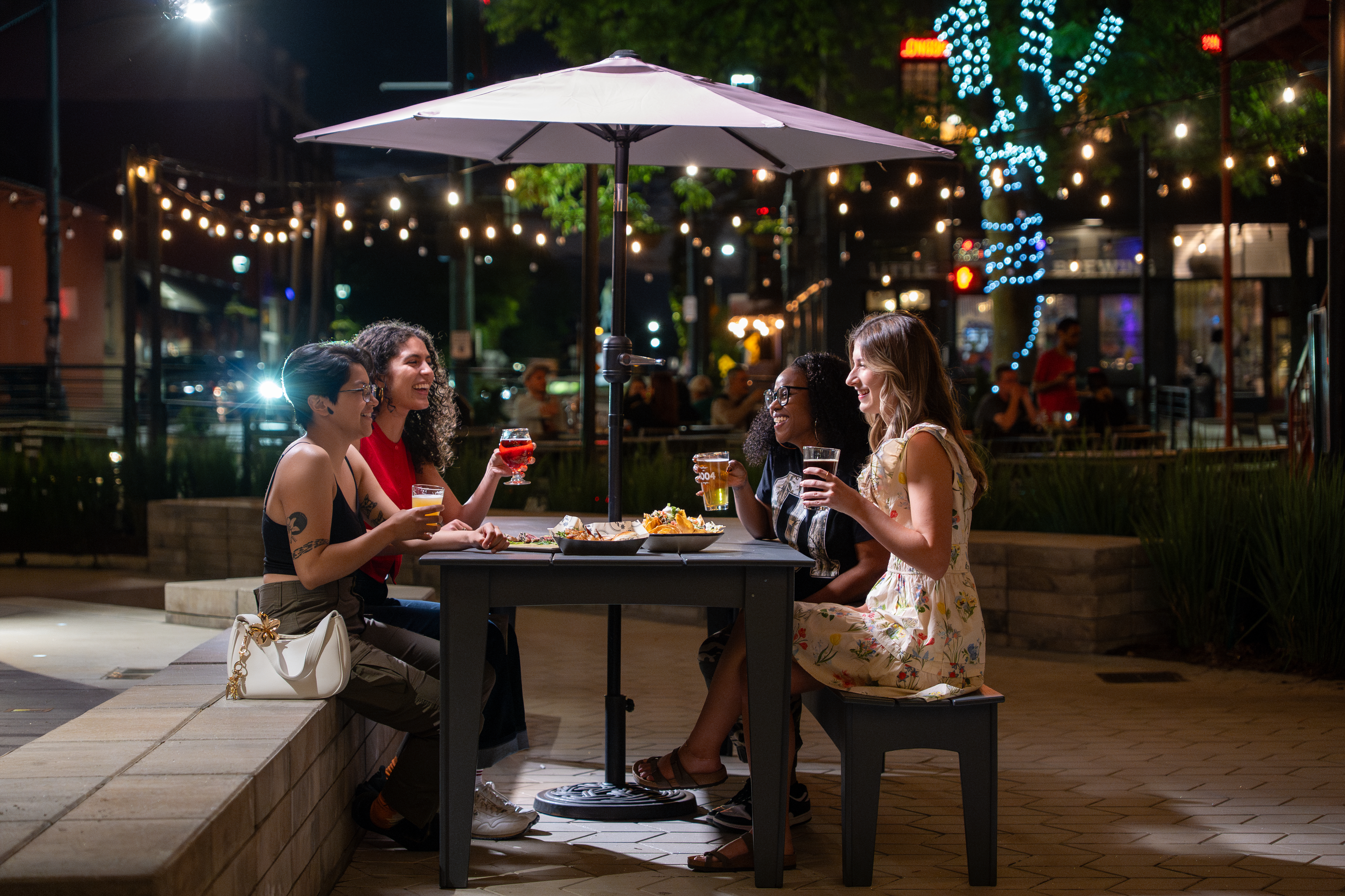 Group of four adults sitting together at dinner