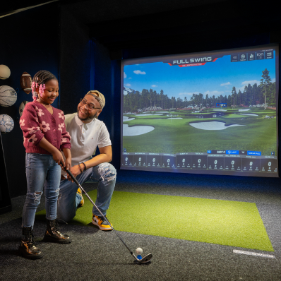 Man and daughter playing virtual golf