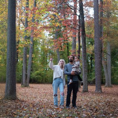 Family in the fall surrounded by trees
